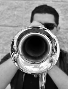 Isaiah McPeak, COO of Pinwheel playing the trumpet. 