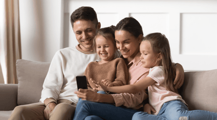 parents-with-children-using-kids-smartphone