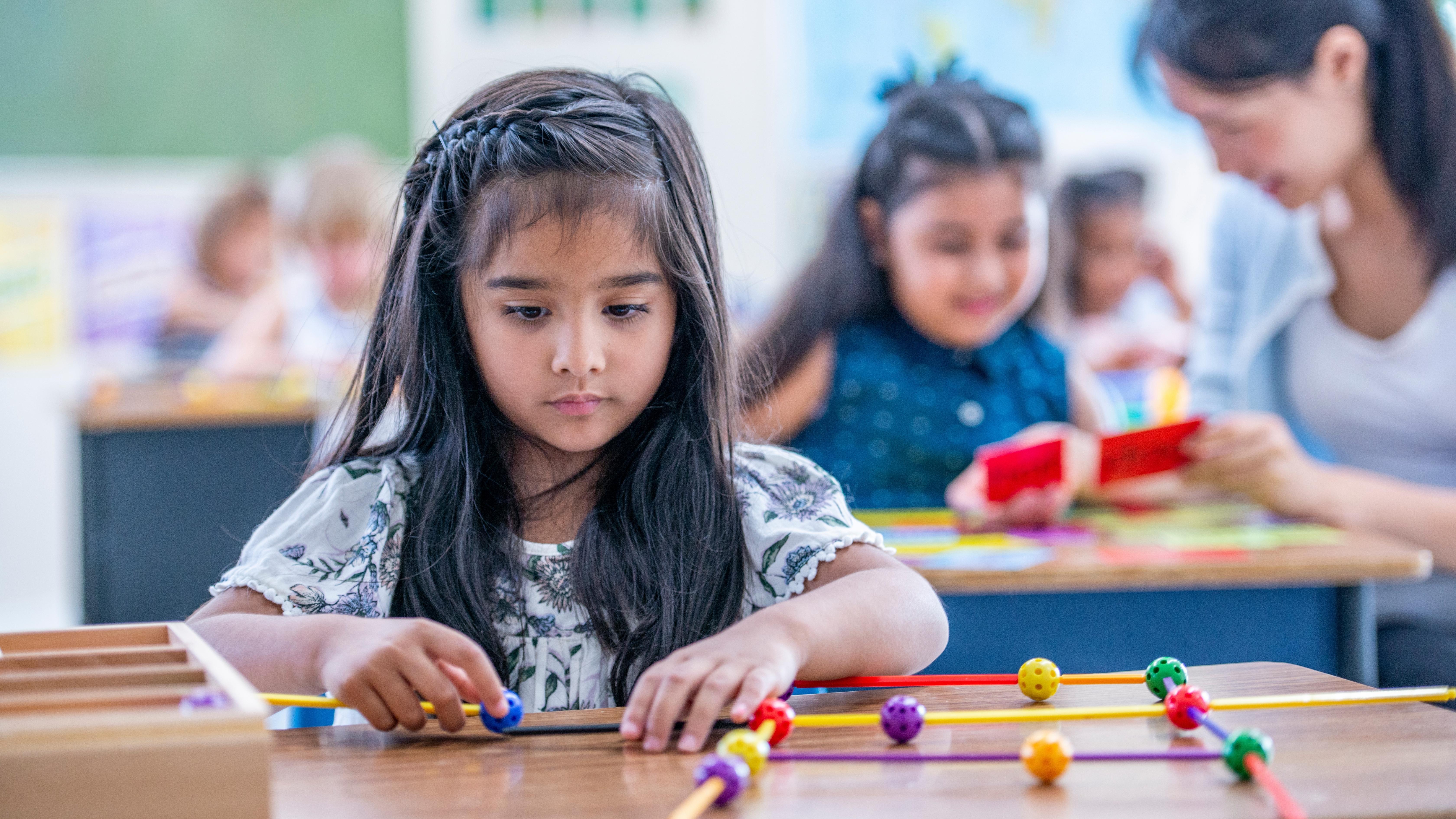 Elementary Child in school. Phone for kids. Pinwheel, Healthy phone for kids.